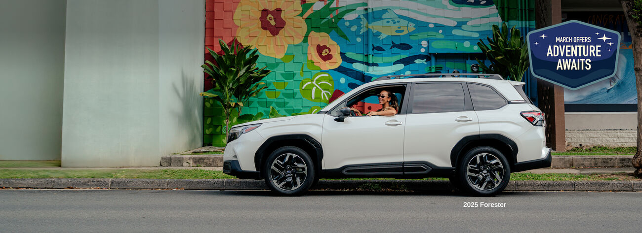 Forester parked by street mural.